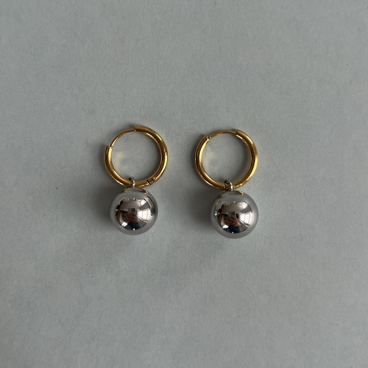 Gold colour hoops with silver colour pendants