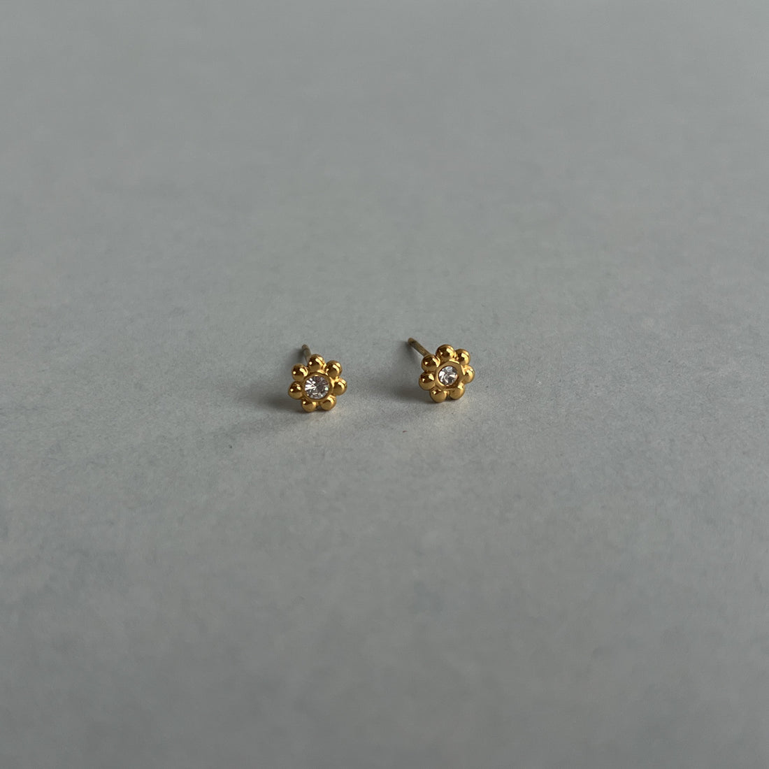 Gold colour small flower studs with zircons