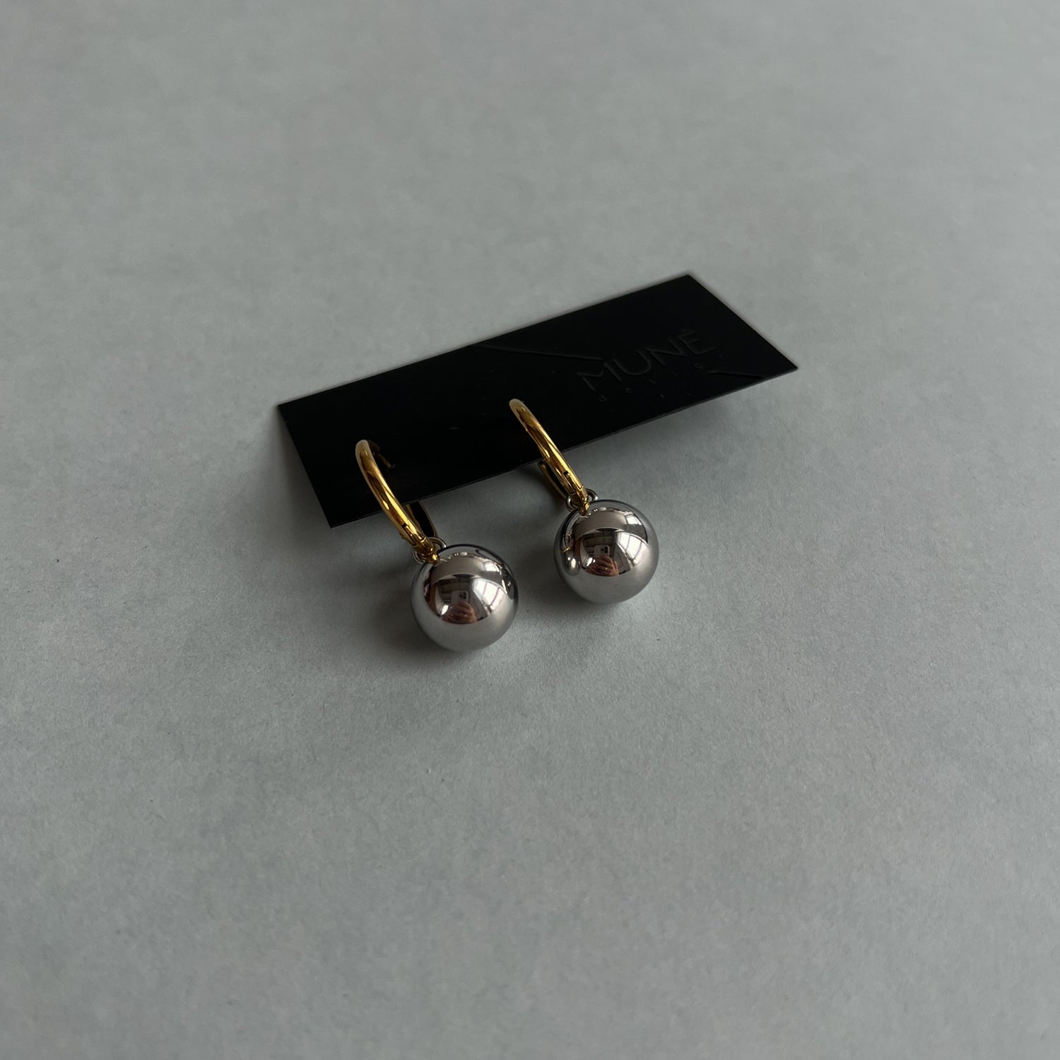 Gold colour hoops with silver colour pendants