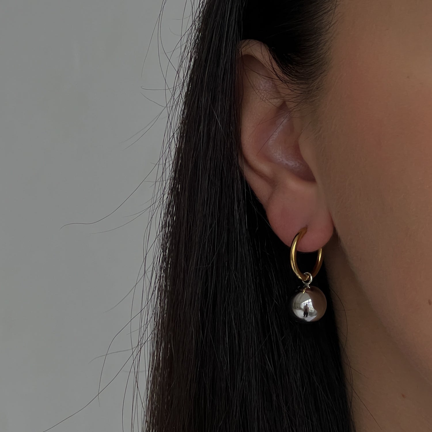 Gold colour hoops with silver colour pendants