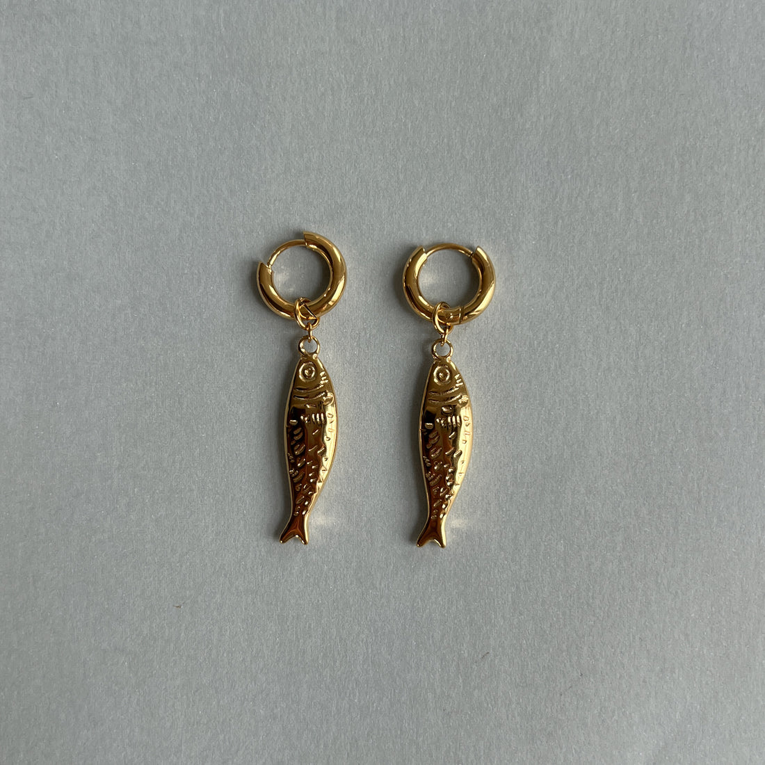 Gold colour hoops with fish pendants